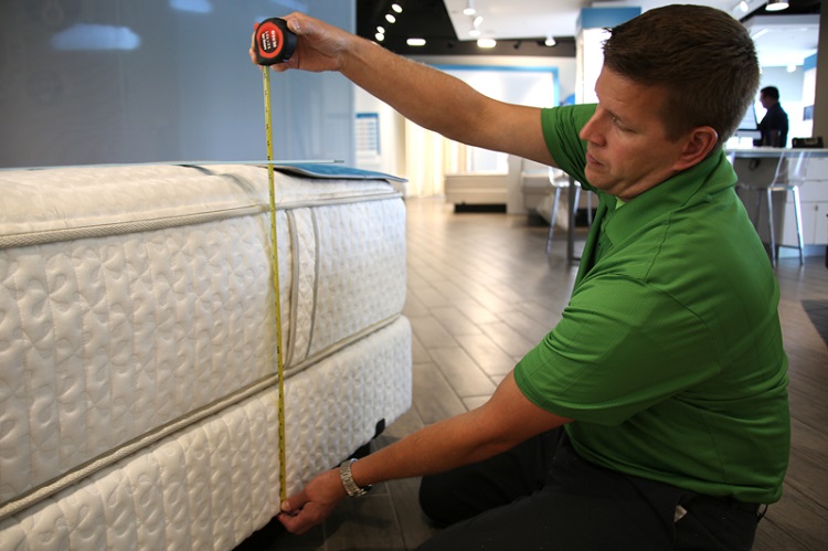 Man In Store Measuring Mattress